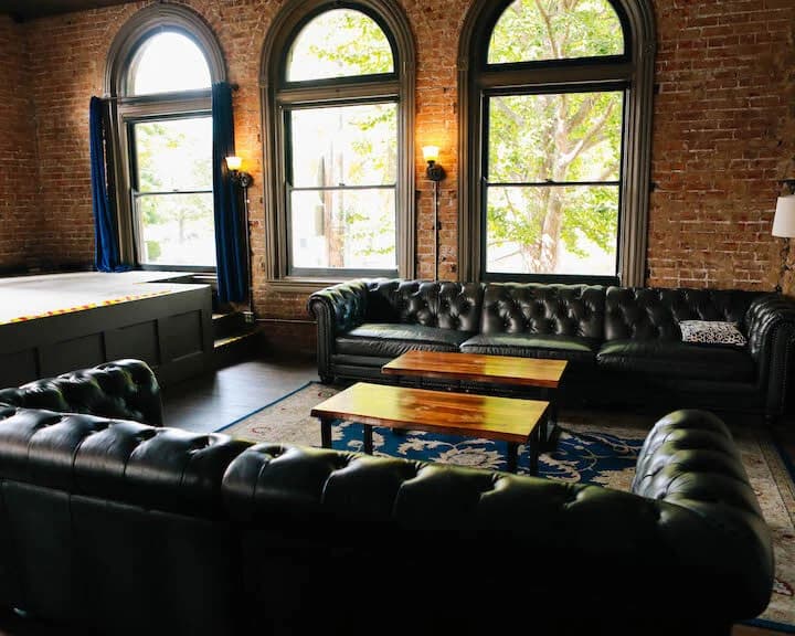 Chesterfields beneath the arched windows in the Bourbon Lounge